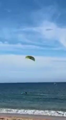 Water sports enthusiast kitesurfs, wing foils off Barbate coast