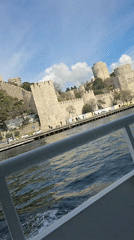 Boat passenger films historic Rumeli Hisarı fortress from Istanbul waters