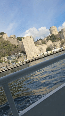 Boat passenger films historic Rumeli Hisarı fortress from Istanbul waters