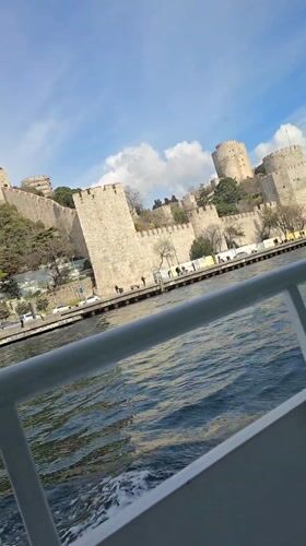 Boat passenger films historic Rumeli Hisarı fortress from Istanbul waters