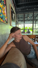 Woman rests at cafe in Marga, Indonesia