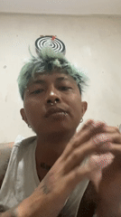 Tattooed individual with green hair photographed in Kuta