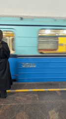 Commuter waits on Saint Petersburg metro platform during morning rush