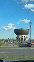 Ornate cauldron-shaped building seen from street level