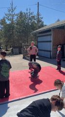 Youth practice dance moves outdoors in Russian village