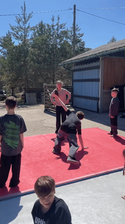 Youth practice dance moves outdoors in Russian village