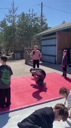 Youth practice dance moves outdoors in Russian village