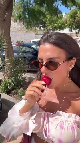 Woman enjoys strawberries during morning photo session in Bodrum