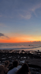 Coastal scenes captured: sunset shoreline and beach with umbrellas