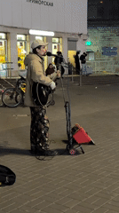 Street musician performs outdoors at night in Saint Petersburg
