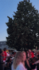 Outdoor crowd watches soccer and live acts at Aperol Spritz event