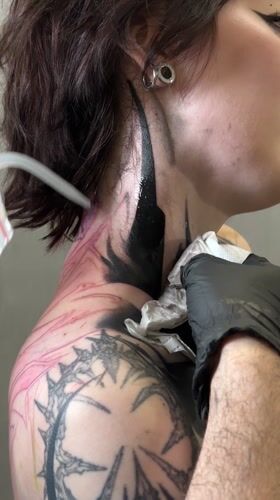 Person gets neck tattoo in Moscow