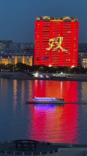 Blagoveshchensk riverfront glowing at dusk across the Amur