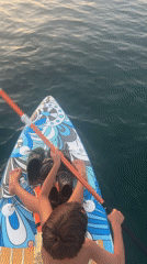 Paddleboarding and city architecture along Nha Trang's waterfront