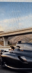 Formula 1 racing game footage captured in mountainous setting