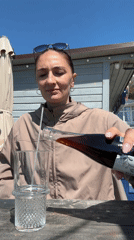 Mother enjoys waterfront drink while baby naps in Sochi