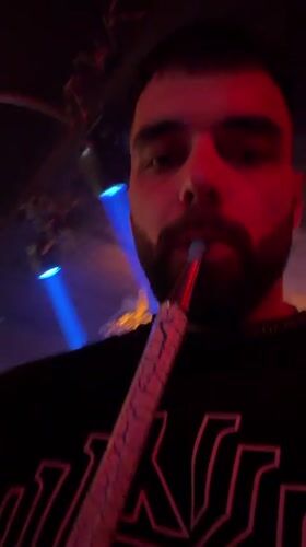 Man smokes hookah on commercial street in Nesebar, Bulgaria