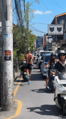 Early morning jogger runs through busy North Kuta traffic