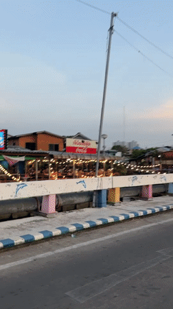 Vehicle captures Pattaya street-to-waterfront transition during golden hour