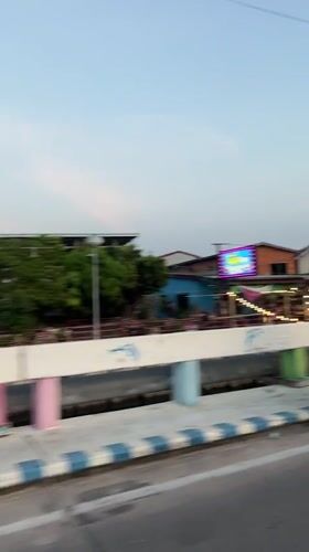 Vehicle captures Pattaya street-to-waterfront transition during golden hour