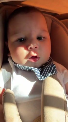 Baby in car seat, red string bracelet, Pleven Bulgaria