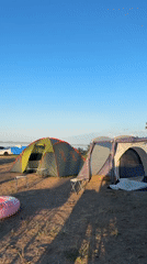 Lakeside campsite in Жемчужный under clear summer skies