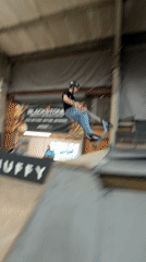 Young riders perform aerial tricks at Corby indoor skatepark