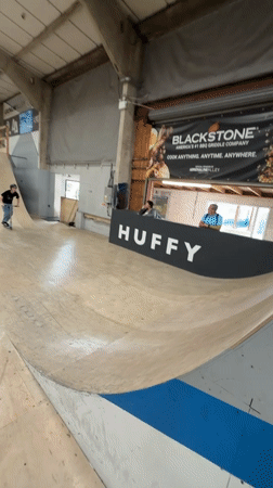 Young riders perform aerial tricks at Corby indoor skatepark