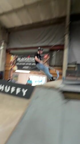 Young riders perform aerial tricks at Corby indoor skatepark