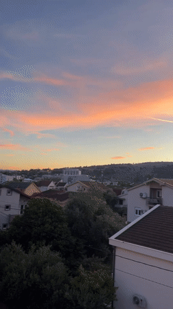 Sunset scenes in Podgorica residential area with parked yellow Fiat