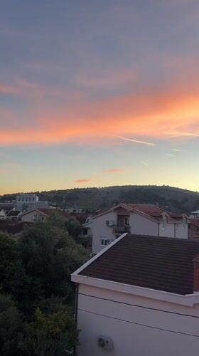 Sunset scenes in Podgorica residential area with parked yellow Fiat
