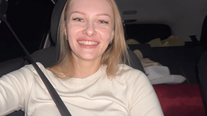 Woman photographed smiling in car driver's seat in Perm