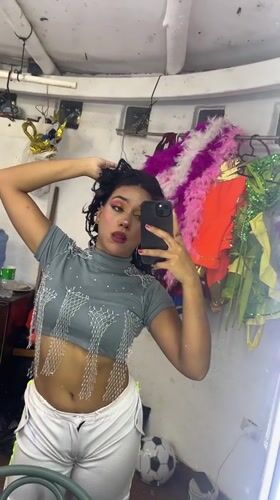 Pink-costumed stage performance and backstage selfies in Porlamar