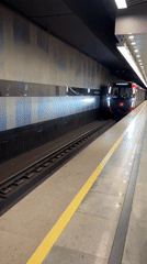 Subway train passes through Khimki station with passengers aboard