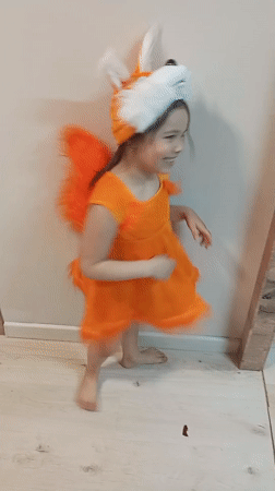 Child in fox costume dances in Russian town