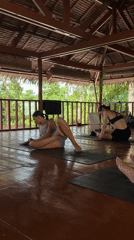 Woman practices yoga at tropical pavilion in General Luna