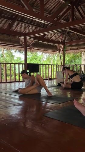 Woman practices yoga at tropical pavilion in General Luna