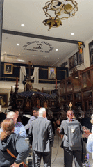 Visitors view ornate Mary statue display in Málaga religious venue