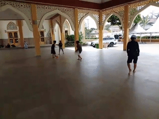 Kids playing soccer in a mosque courtyard, Indonesia