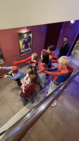 Spider-Man cosplayers meet fans on a Saint Petersburg staircase.