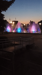 Colorful fountain display illuminates Smila public square at dusk