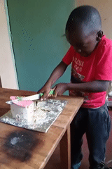 Young people play volleyball, celebrate with cake in Turbo, Kenya