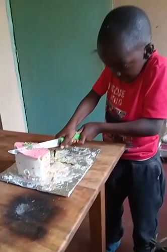 Young people play volleyball, celebrate with cake in Turbo, Kenya