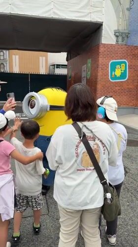 Early morning visitors enjoy Universal Studios Japan attractions and characters