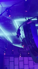 Aerial acrobat performs at illuminated nightclub venue in Varna