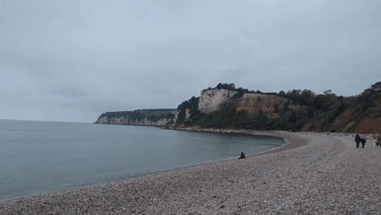 Visitors enjoy Budleigh Salterton beach despite overcast weather