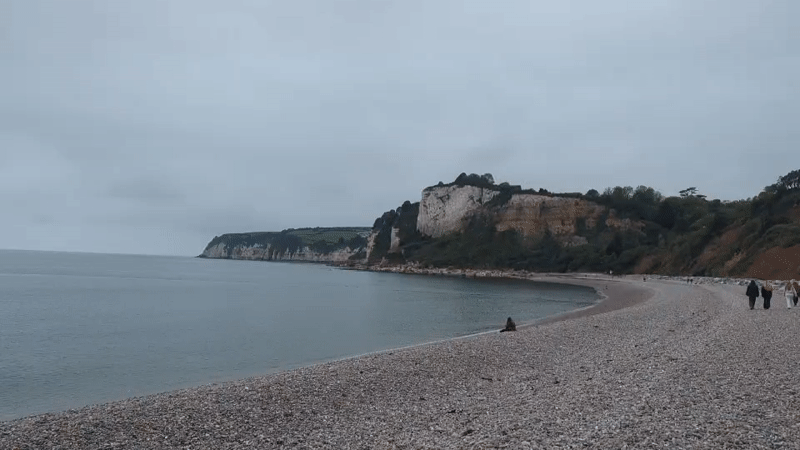 Visitors enjoy Budleigh Salterton beach despite overcast weather