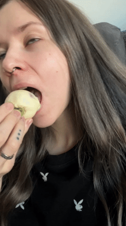 Woman enjoys chocolate strawberries on sofa in Khimki