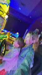Mother and child enjoy arcade games at Polish shopping mall
