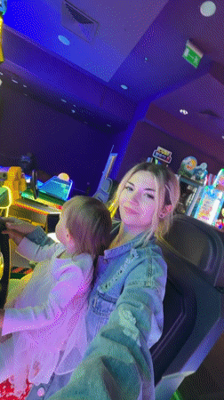Mother and child enjoy arcade games at Polish shopping mall